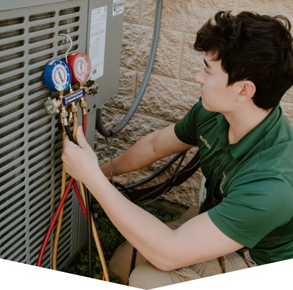 A man working on an air conditioner unit.