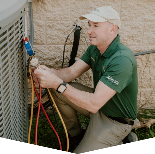 A man working on an air conditioner unit.